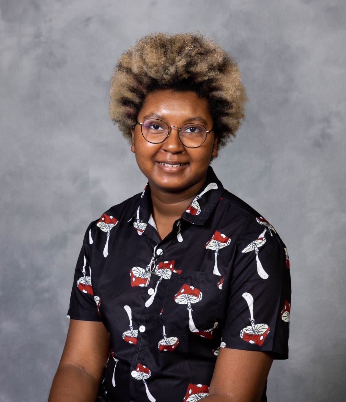 professional headshot of Black person against gray background